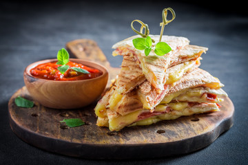 Wall Mural - Spicy quesadilla made of tortilla with sauce and herbs