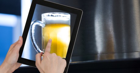 Poster - Hand taking picture of beer glass through digital tablet