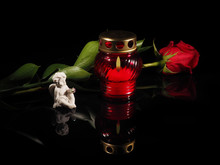 Burning Candle In A Red Glass Candlestick