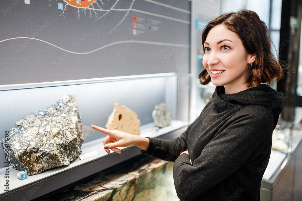 Beautiful Asian happy geologist woman indoors looking at minerals collection, education and science concept - obrazy, fototapety, plakaty 