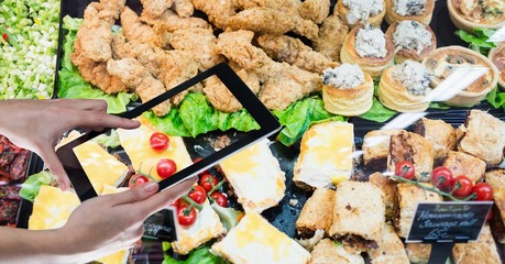 Wall Mural - Hands taking picture of food through digital tablet