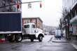 Day cab Semi truck trailer turn on urban city street