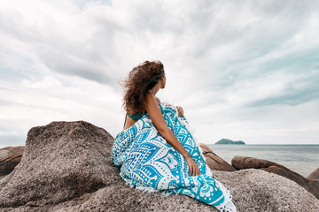 Wall Mural - beautiful young woman covered with stylish mat on the beach