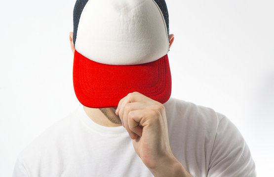 Fototapete - the man, guy in the blank white, red baseball cap, on a white background, mock up, free space, logo presentation , template for print, design,