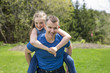 © Louis-Paul Photo - portrait of a father carrying teen girl on back at the park