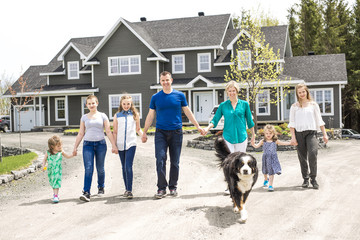 happy family standing in front of the house