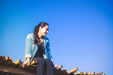 Fototapeta Londyn - Woman sitting on bridge and blue sky