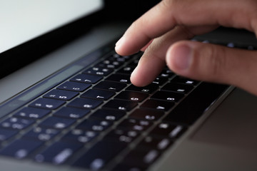 Poster - close-up finger typing on keyboard computer working at night