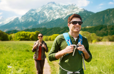 Poster - happy couple with backpacks hiking outdoors