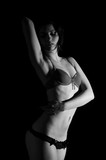Fototapeta  - young sexy female erotic posing on black background