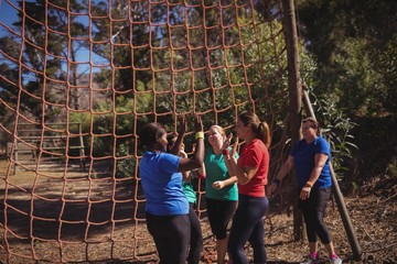 Wall Mural - Group of fit women giving high five to each other 