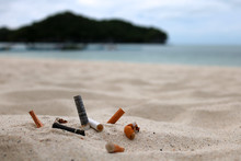 Cigarette Butts And The Ashtray On The Beach.  