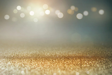 vintage glitter gold, dark blue and black lights bokeh background. defocused.