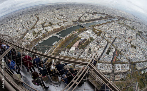 Tourists Look Over The French Capital From The Third Floor Of The