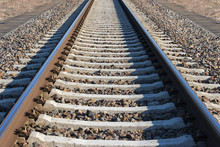 Fragment Of Railroad Tracks, Rails And Sleepers On Gravel