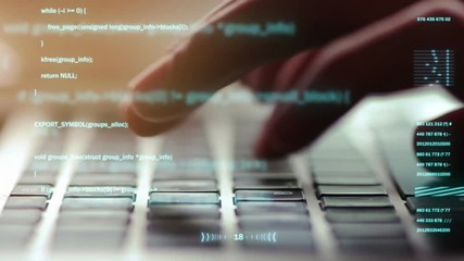 Extreme close-up of human hands typing on laptop keyboard, selective focus