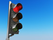 Traffic light with red color on blue sky background. Stop concept.