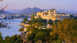 Panorama view of  Udaipur City Palace, island and tourist boat on lake Pichola in the evening, on sunset, Udaipur, Rajasthan, India