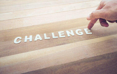 Wall Mural - Challenge word with male hand on wood table.Business marketing,analysis concept