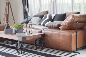 Wall Mural - Wood center table with wheel and light brown leather sofa in industrial style decoration