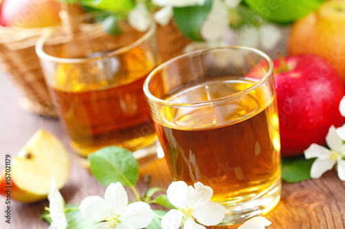 Zdjęcie XXL Słodki sok jabłkowy, jabłka i kwiaty na stole