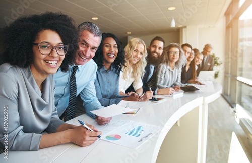 Fotografía Cheerful multiracial colleagues looking at camera in office