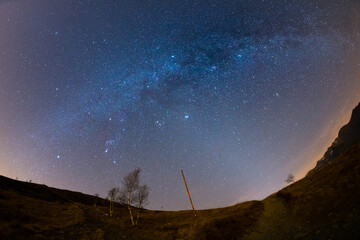 Wall Mural - the wonderful starry sky on christmas time and the majestic high mountain range of the italian frenc