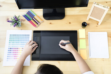 Leinwandbilder - Graphic designer using graphics tablet and computer in the office