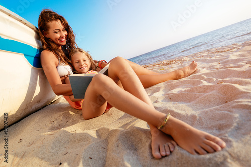 Poster Mom And Daughter Enjoying On The Beach