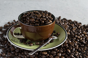 Cup of coffee bean on the stone table.