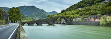 Panorama With Bridge And Green River In Italy