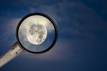 Wall Mural - full moon and cloudy sky with magnifying glass
