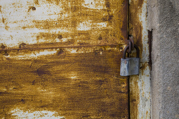 Old rusty door with a lock