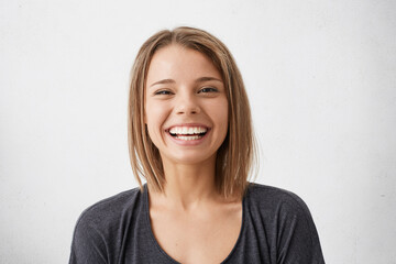 positive human facial expressions and emotions. cheerful attractive teenage girl with bob hairstyle 