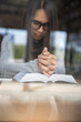 Beautiful woman (christian) hands on bible,she is praying and reading bible.Asian woman reading books for exam in library.