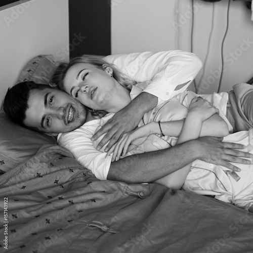 Young Romantic Couple Relaxing And Hugging In Bed Pretty