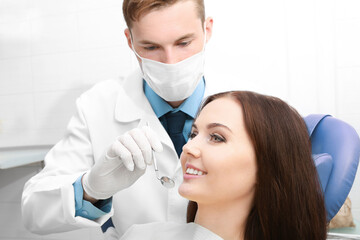 Wall Mural - Dentist examining patient teeth in clinic