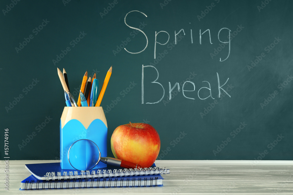 School stationery and "Spring break" text on chalkboard