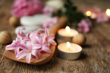 Wall Mural - Beautiful spa composition with flowers and candles on wooden background