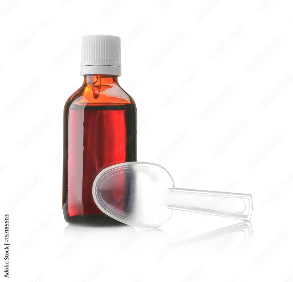 Bottle with cough syrup and measuring spoon on white background