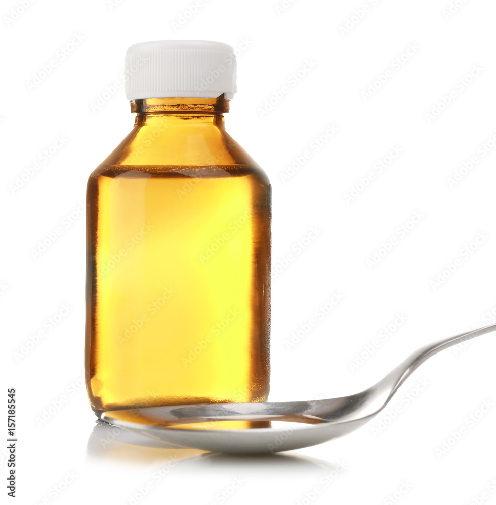 Bottle with cough syrup and poured dose in spoon on white background