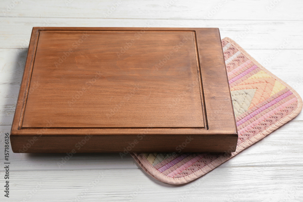 Cutting board on white wooden background