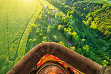 View From Basket In Hot Air Balloon, Flying Above Rural Countryside. Air Travel And Transportation, Beautiful Nature Landscape Shot From Aerial Perspective