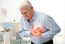 Man With Chest Pain Suffering From Heart Attack In Office