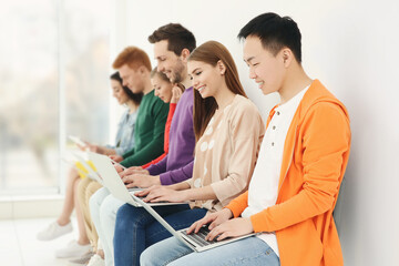 Poster - Young people with laptops sitting on chairs