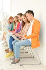 Poster - Young people with laptops sitting on chairs