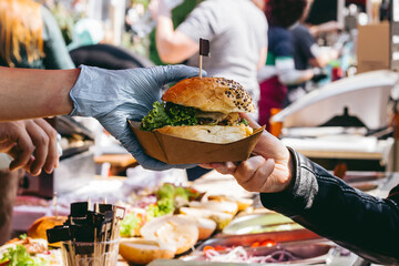 Delicious fresh burger on food market, ready to eat. Close-up