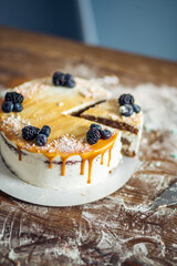 Wall Mural - carrot cake with walnuts, prunes and dried apricots on a dark wood background. tinting. selective focus