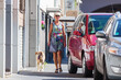 woman walking in the city with a dog