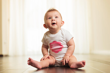 excited and curious little baby girl looks up